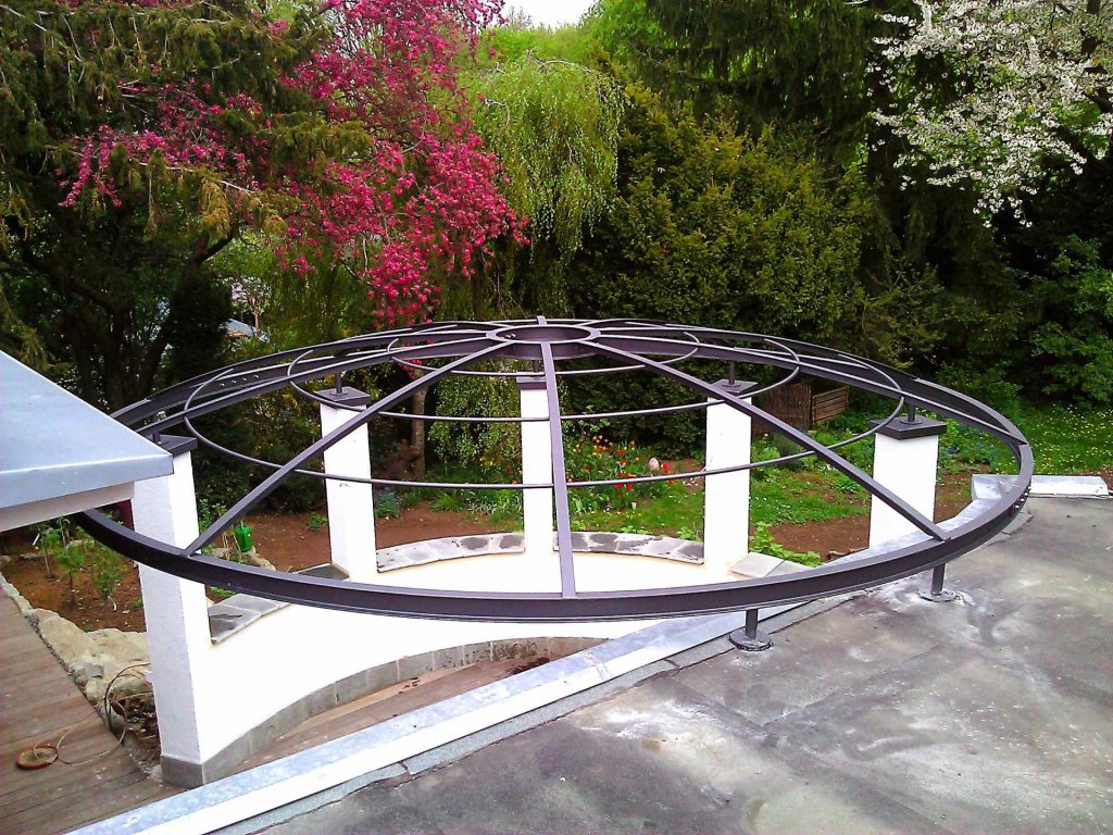 Runde Pergola als Kuppeldach auf gemauerten Pfeilern.